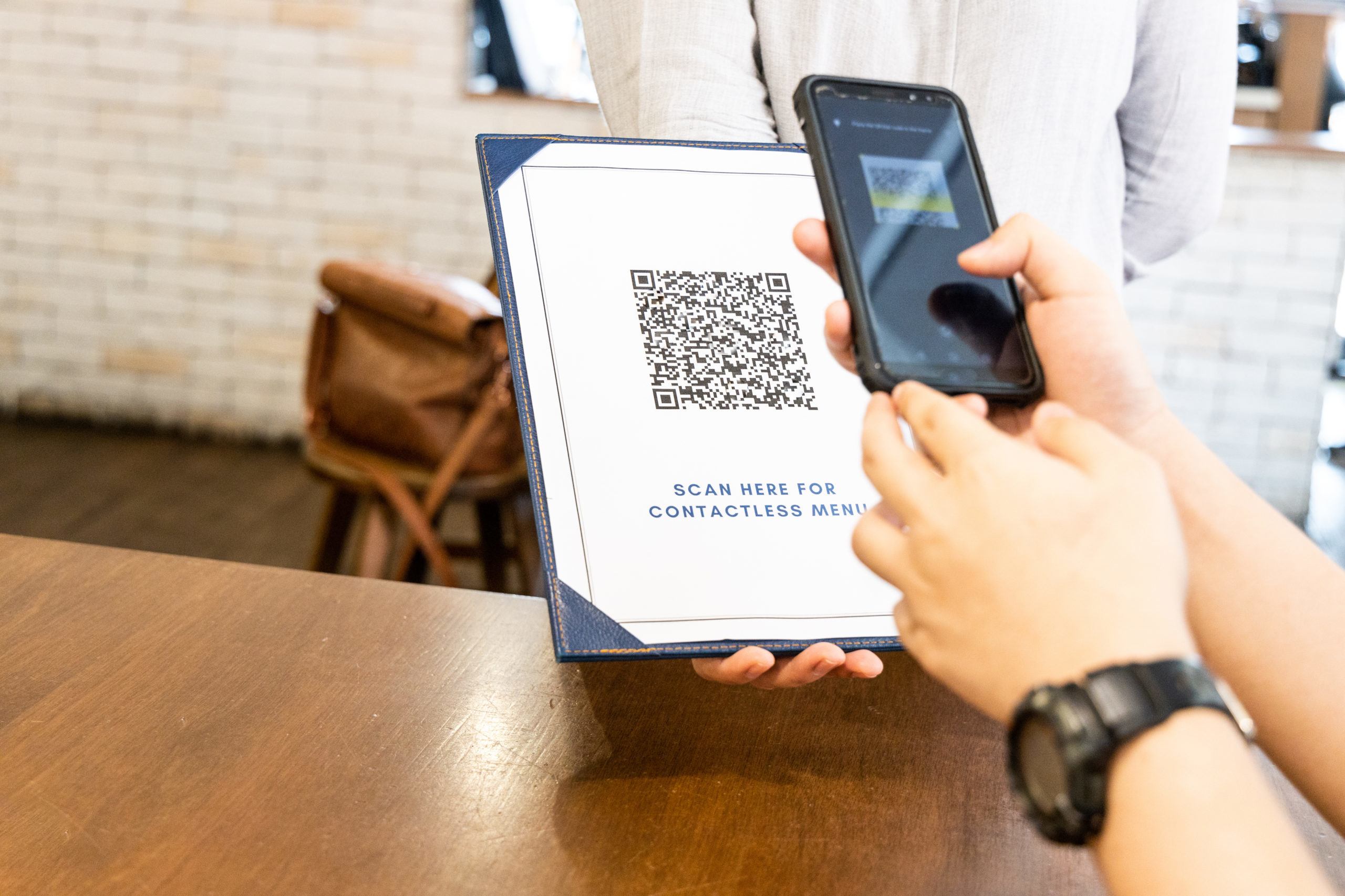 Person scanning contactless menu QR code with smartphone as new normal. Code edited and not valid