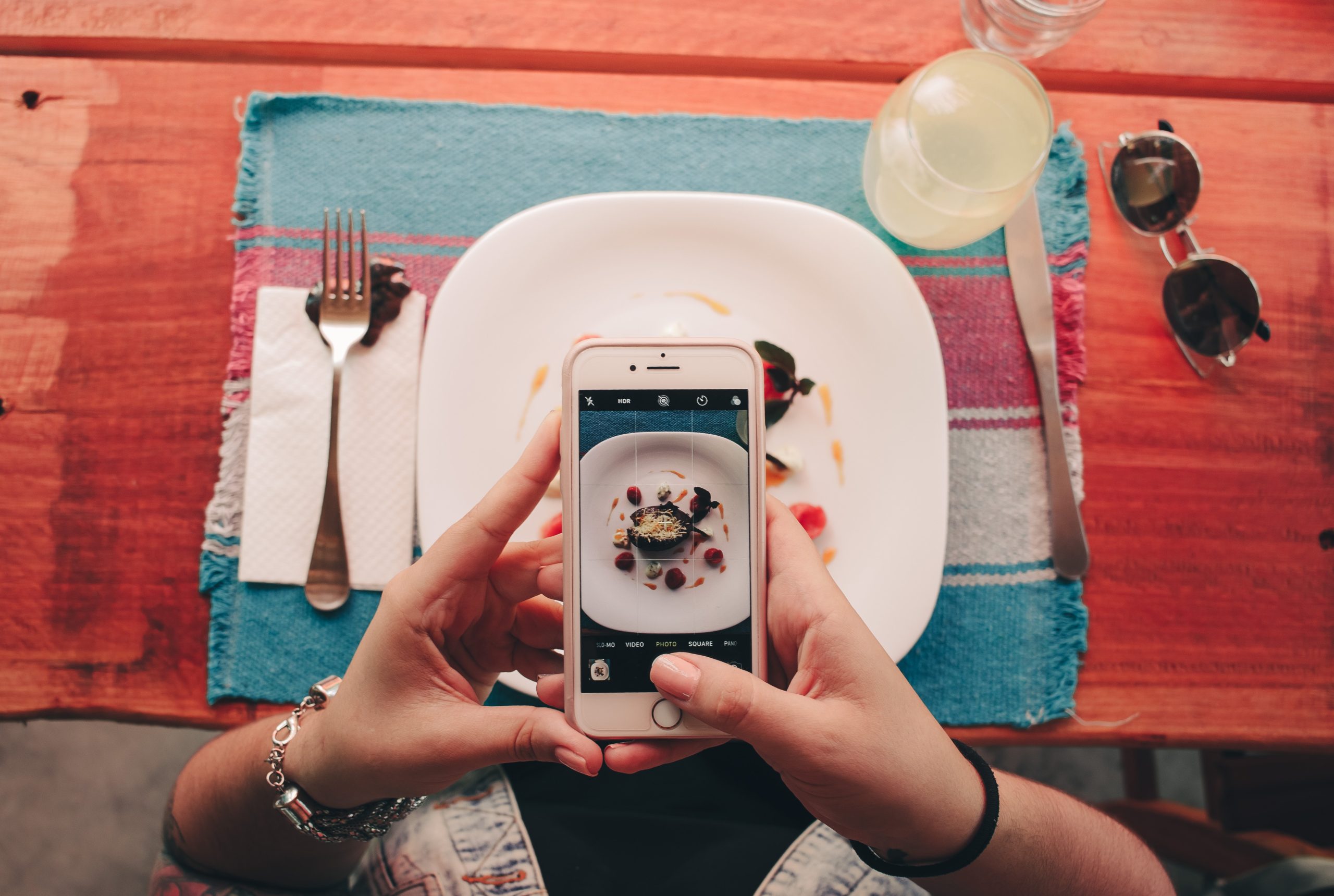 A person clicking a photograph of their food 